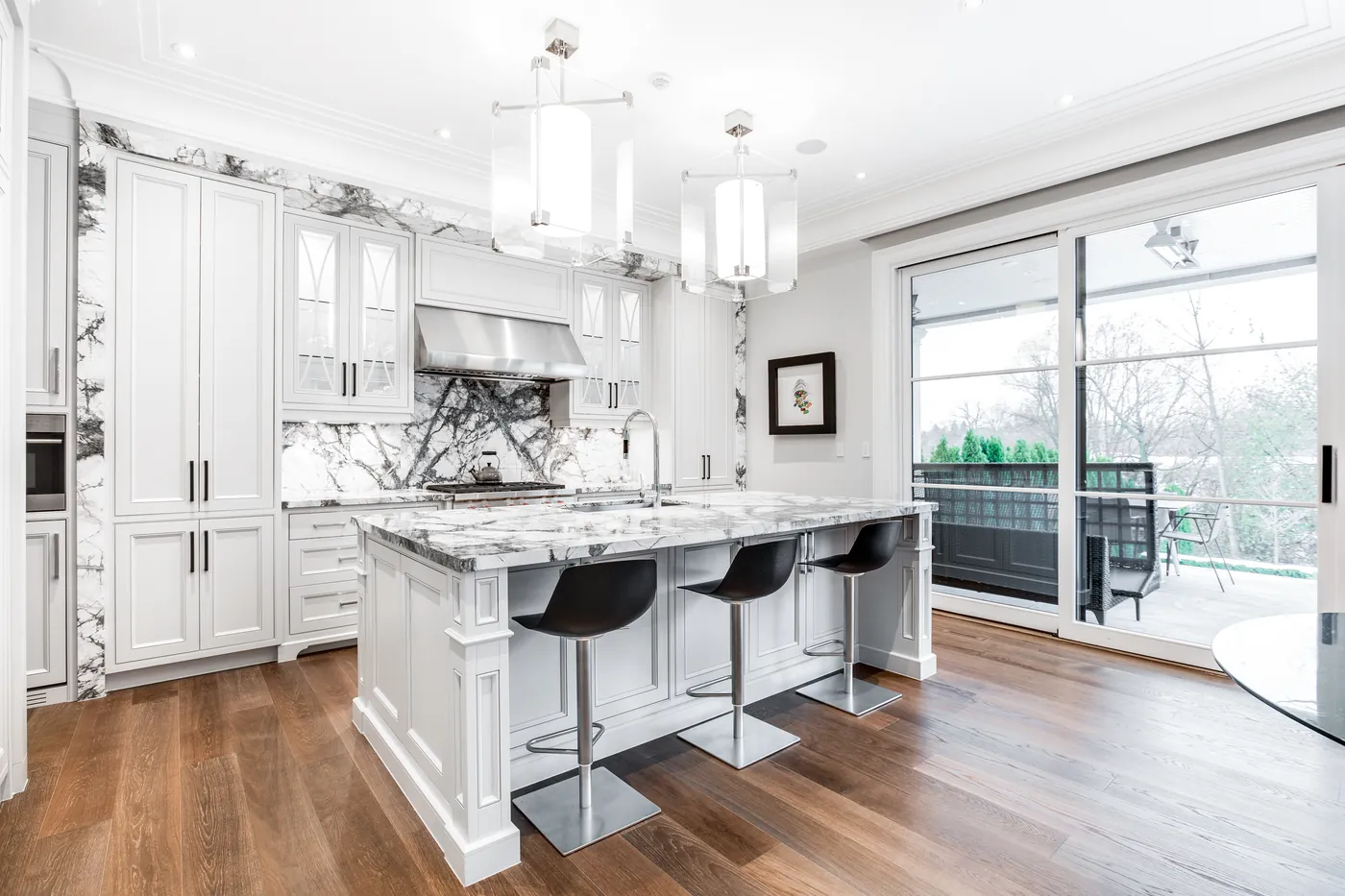 HDR photograph of a white kitchen with island